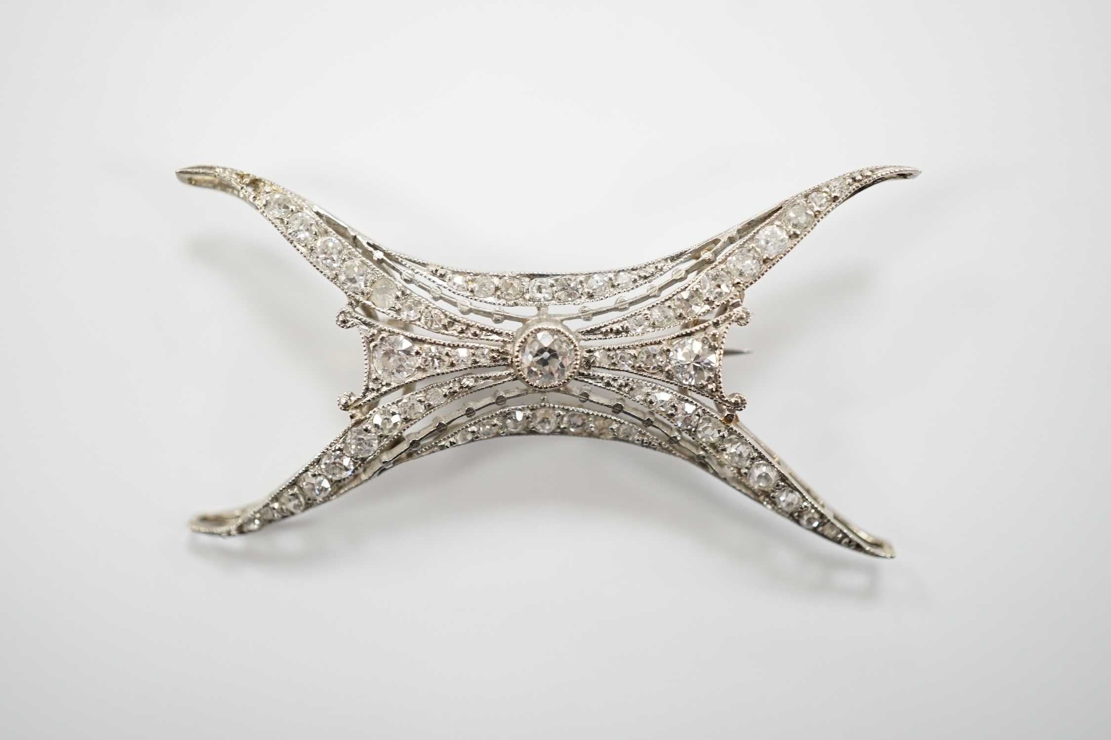A 1920's white metal and millegrain set diamond cluster set brooch, 46mm, gross weight 5.2 grams.